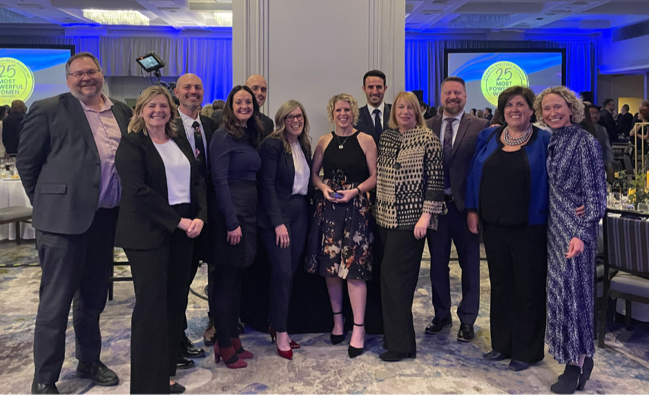 EEG leadership team smiling with suzanne's award